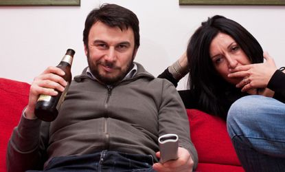 Man watching TV with beer