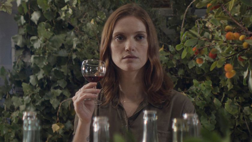 Fleur Geffrier holds a glass of wine up to her face in Drops of God season 2