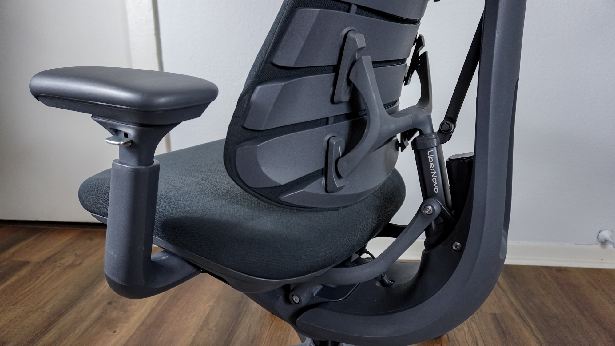 The back of the LiberNovo Omni office chair showing off its motor and the piston that moves the backrest forward or backward