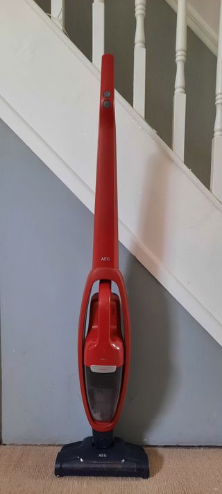 AEG QX6 Animal vacuum cleaner standing upright against staircase