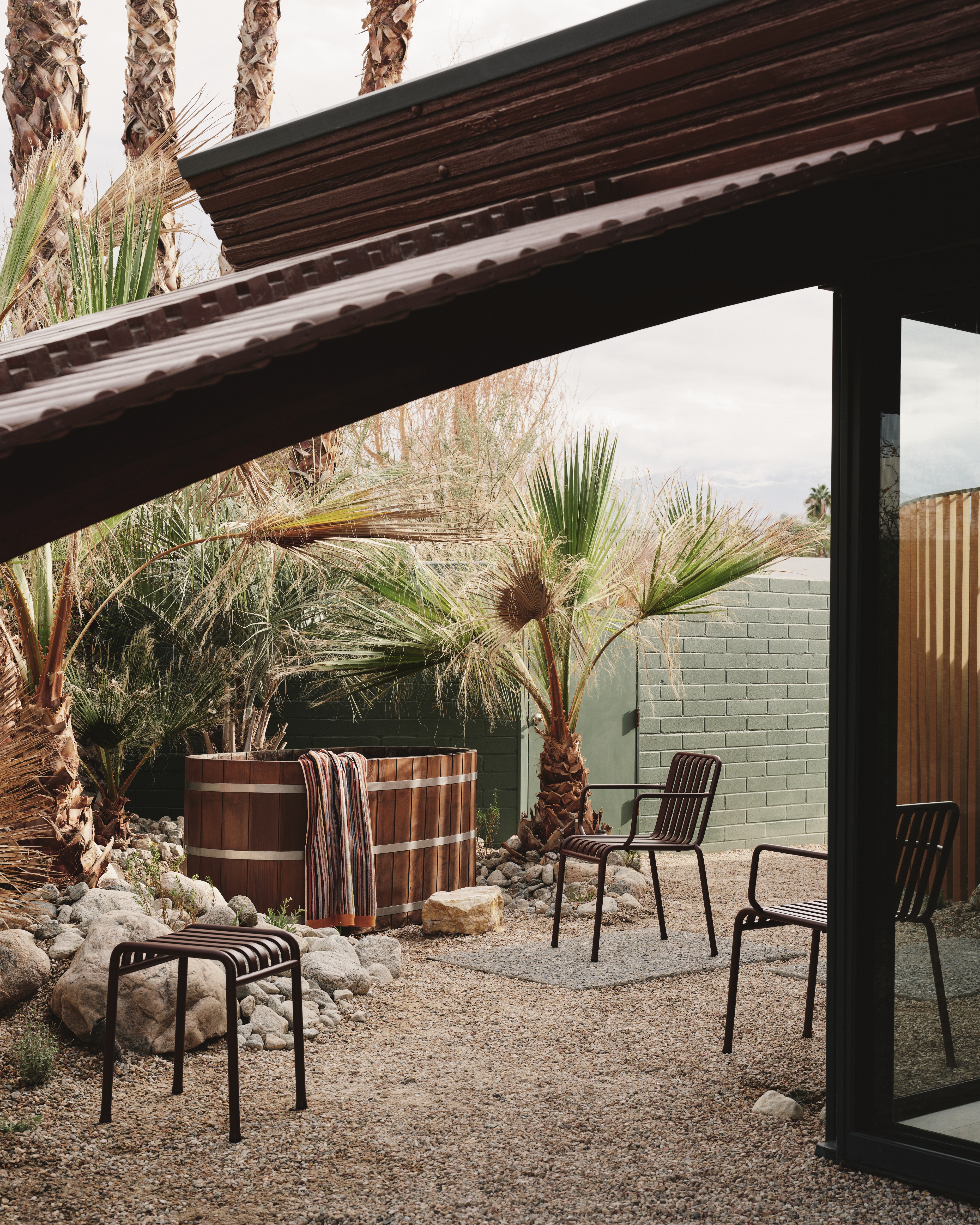 A Californian desert house from the mid 20th-century is furnished with earthy, stripy furnishings and iconic design pieces.