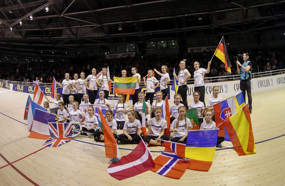 Children fly international flags at the European track championships