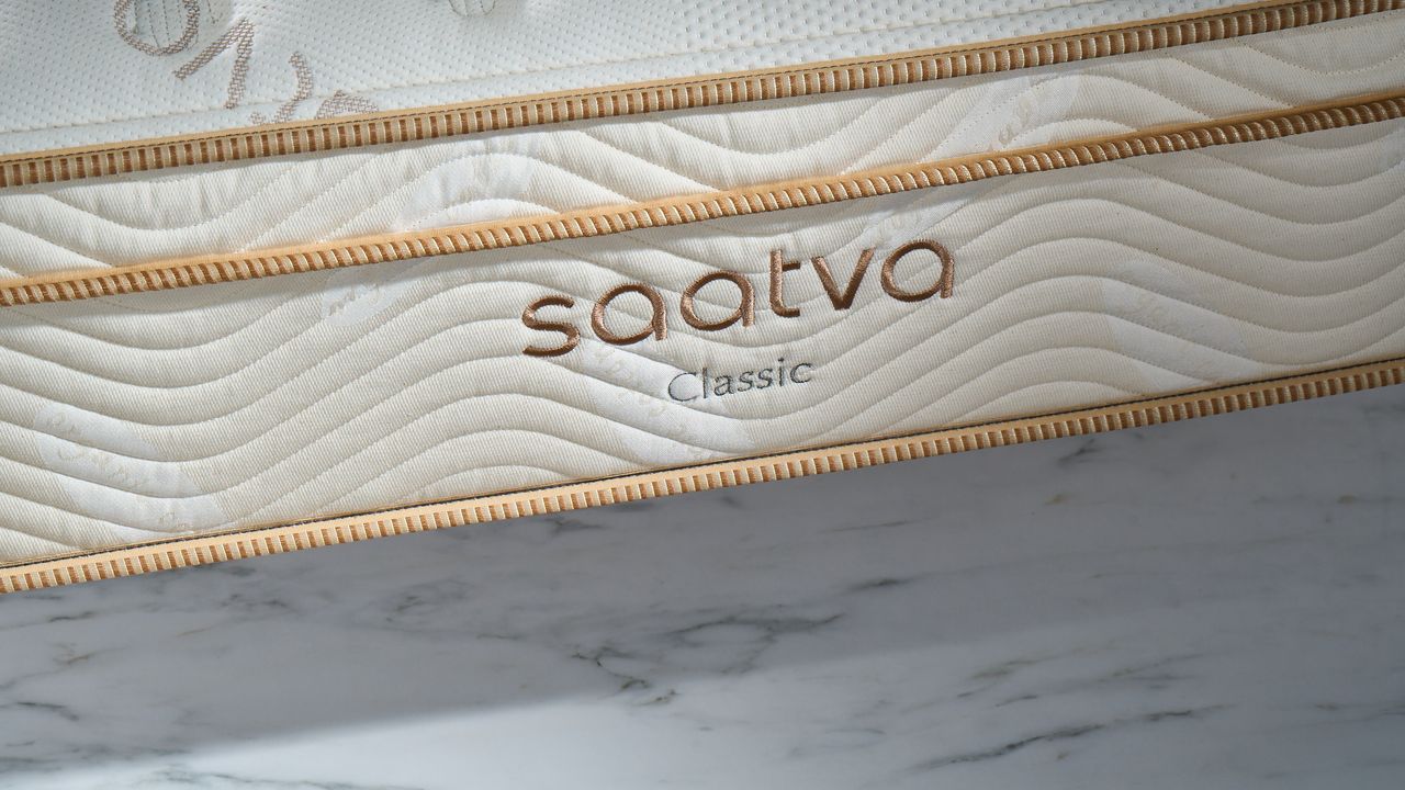 Image shows the Saatva Classic logo on the side of the mattress photographed during our review photography session