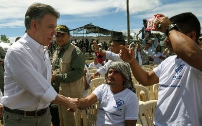 Colombian President Santos meets with former FARC rebels before demilitarization ceremony