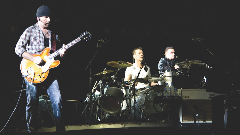 The Edge playing on stage with U2