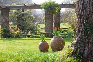 stone pergola in a spring garden