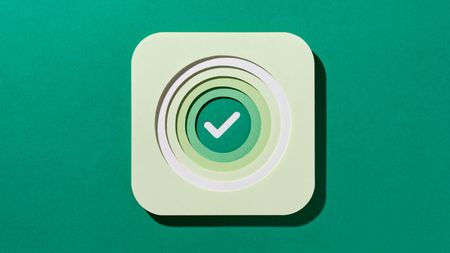 Multi Layered Paper Craft Green Color Check Mark in Concentric Circles on Green Background