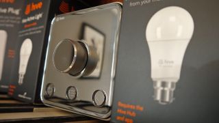 The Hive Thermostat next to a Hive smart bulb