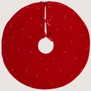 Red Christmas tree skirt with ribbons and white dots