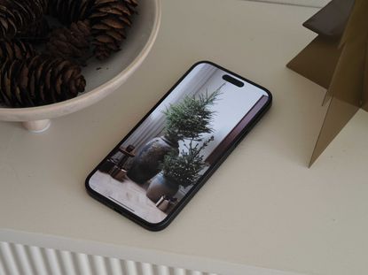 an iphone with a christmas tree on screen