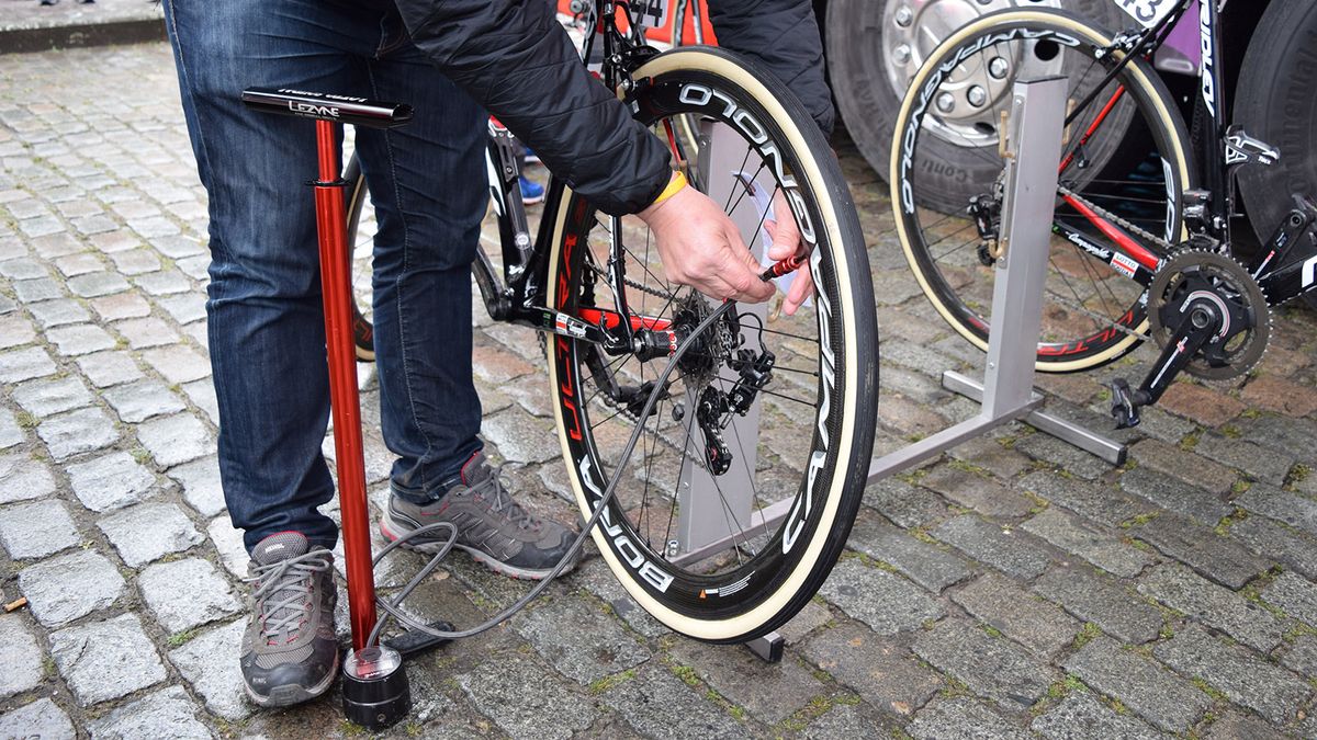 While other teams opt for electric pumps and digital pressure gauges, Lotto-Soudal use a traditional track pump and analog pressure gauge