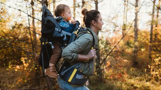 Mother hiking with a baby in a baby carrier