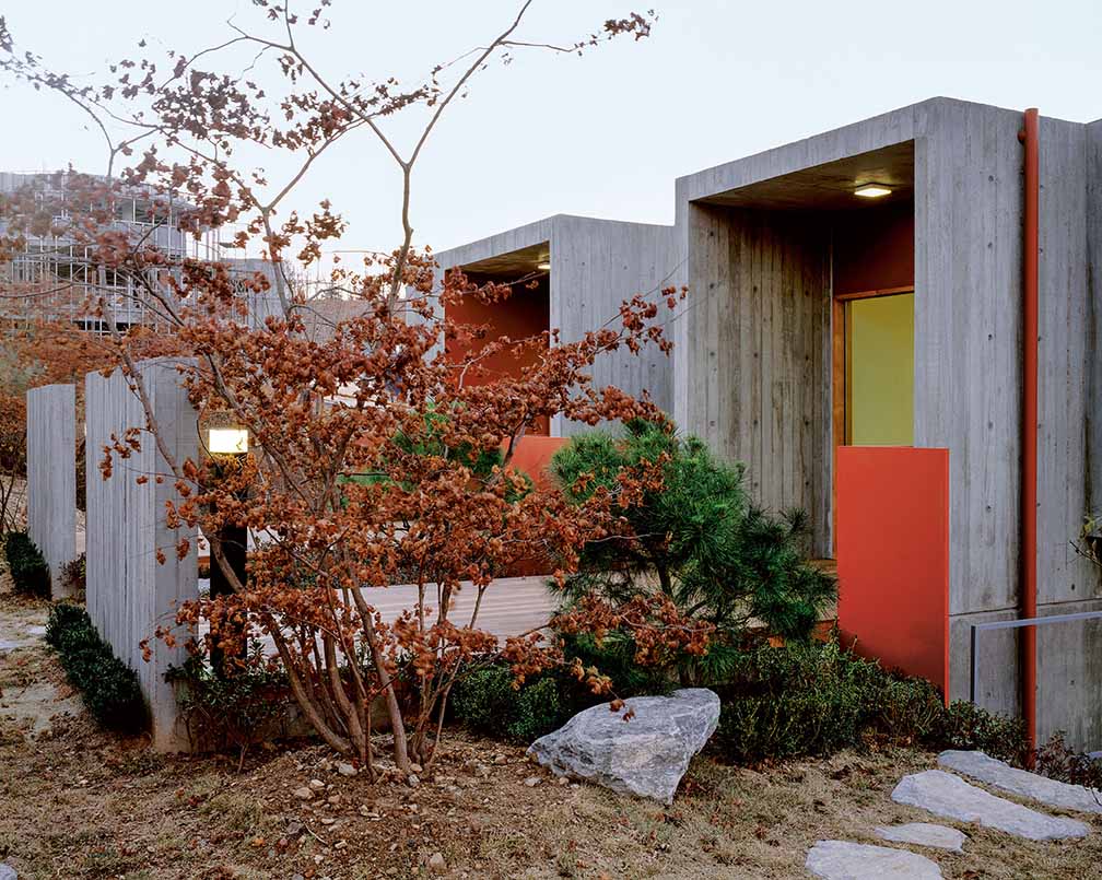 concrete house in countryside featured in Earth Works: Houses by Byoung Cho