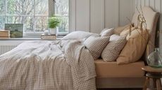 Mushroom Gingham Linen Duvet Cover on a bed against a white wall. 