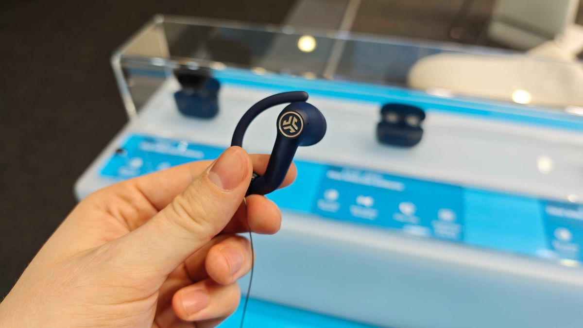 JLab's new earbuds at IFA, on a blue table