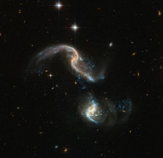 Hubble Space Telescope image of Arp 256, a system of two spiral galaxies about 350 million light-years from Earth that are in the early stages of merging.