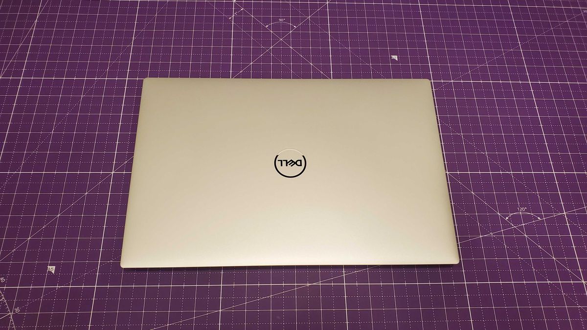 silver laptop sitting on purple desk