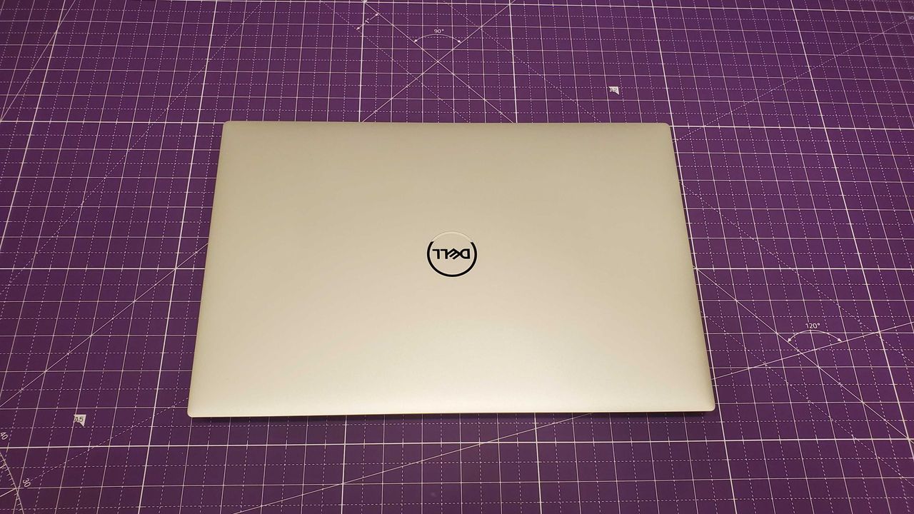 silver laptop sitting on purple desk