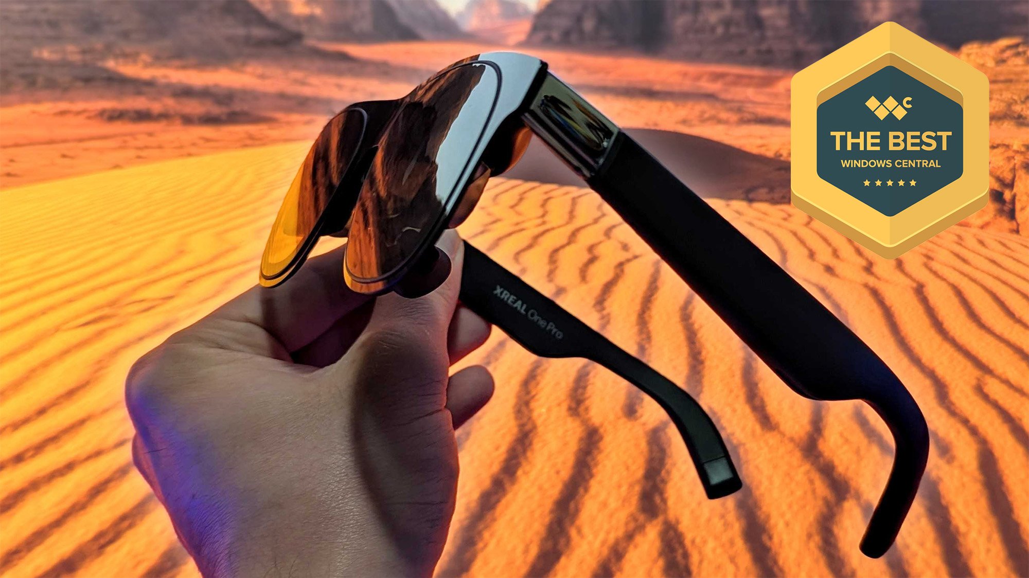 XREAL One Pro AR glasses held in hand, with Windows Central &quot;The Best&quot; award badge