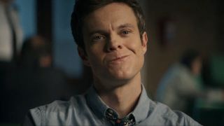 Jack Quaid half smiling in Novocaine.