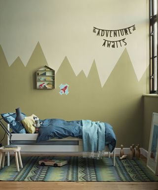 An example of kids' room paint ideas with a two-color mural resembling a mountain range, painted in shades of pale brown-green.