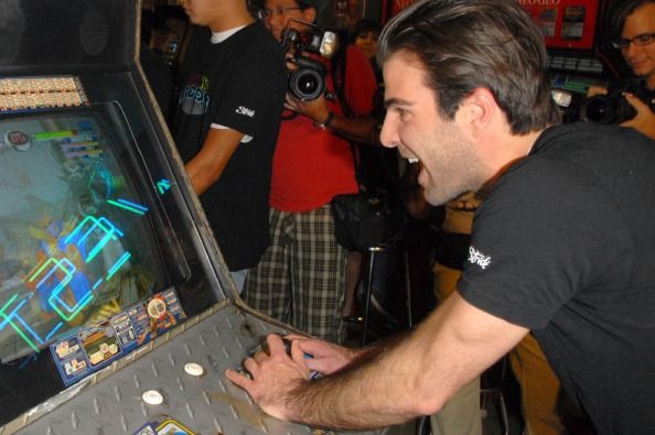 Zachary Quinto playing an arcade game