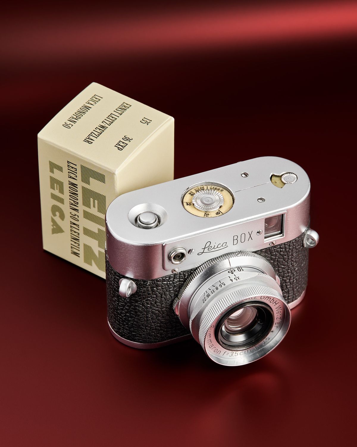 The working Leica Box camera prototype from the mid 1950s on a red background