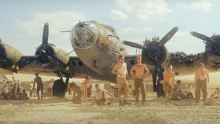 A bunch of soldiers standing in front of a plane during the Apple TV Plus show, Masters of the Air.