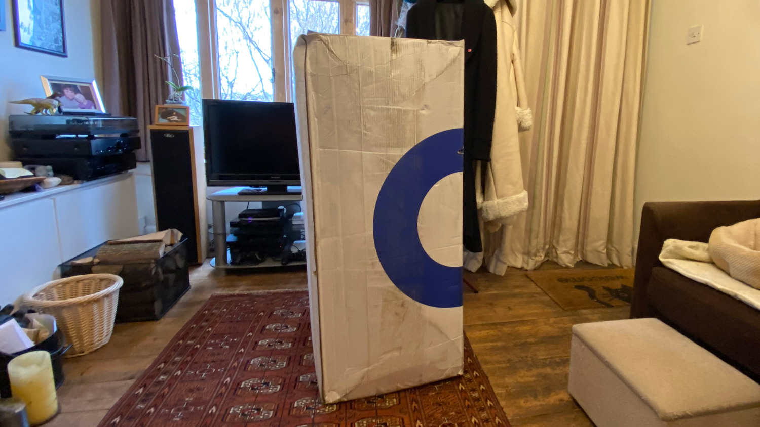 The Amerisleep AS3 Hybrid mattress in its box, in a living room