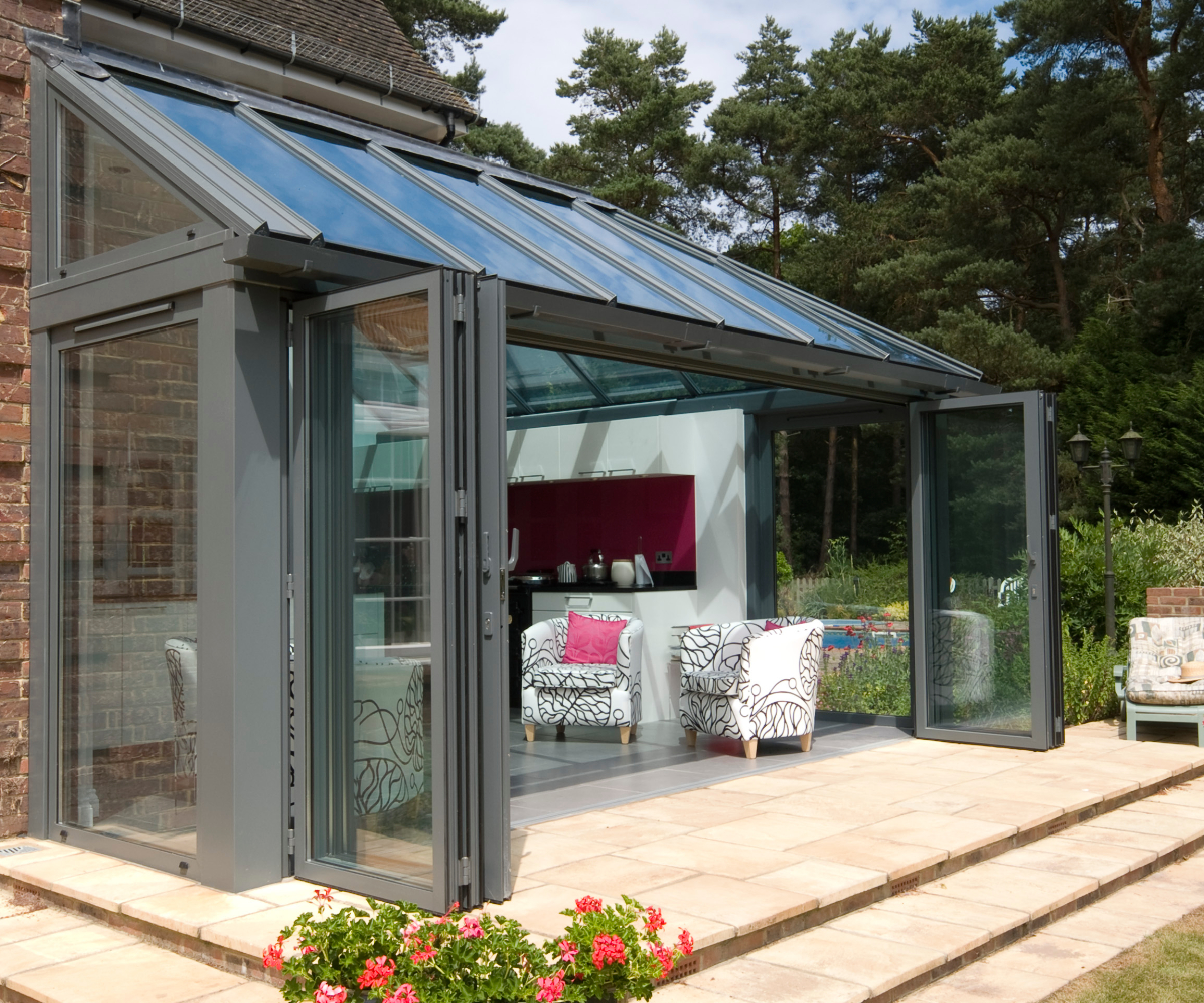 glass and dark grey aluminium lean to extension leading to garden