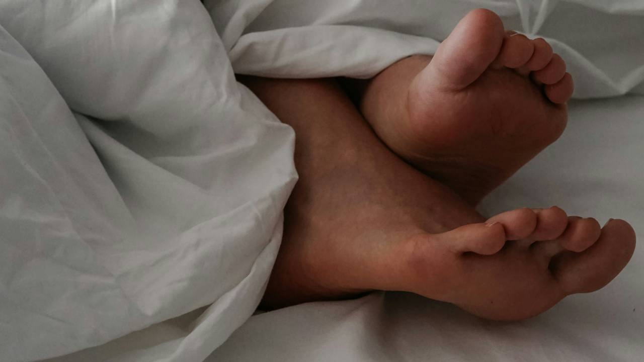 Feet sticking out from a duvet