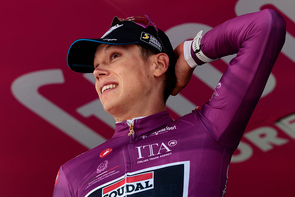 Soudal Quick-Step French rider Paul Magnier wearing the points classification mauve jersey (Maglia Ciclamino) reacts on the podium after the 11th stage of the Giro d'Italia 2026 - Tour of Italy cycling race between Porcari and Chiavari, Italy, on May 20, 2026. (Photo by Luca Bettini / AFP)