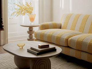 living room with striped yellow sofa