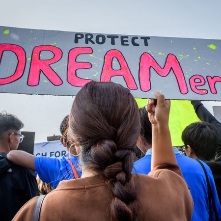 participant holding a protest sign at the rally immigration