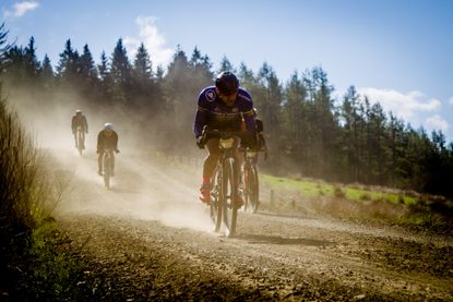 riders racing gravel on UK forest tracks