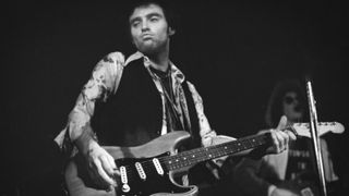 Nils Lofgren performs on stage in Amsterdam, Netherlands, 1975.