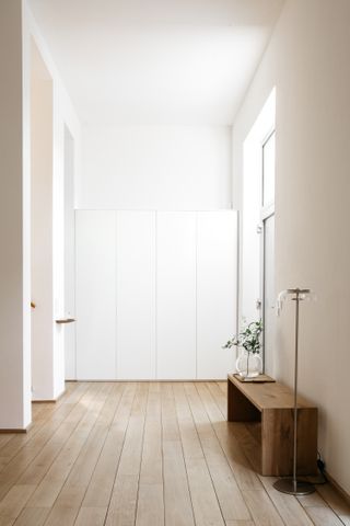 white minimal entryway with hidden storage