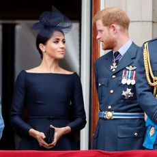 london, united kingdom july 10 embargoed for publication in uk newspapers until 24 hours after create date and time queen elizabeth ii, meghan, duchess of sussex and prince harry, duke of sussex watch a flypast to mark the centenary of the royal air force from the balcony of buckingham palace on july 10, 2018 in london, england the 100th birthday of the raf, which was founded on on 1 april 1918, was marked with a centenary parade with the presentation of a new queens colour and flypast of 100 aircraft over buckingham palace photo by max mumbyindigogetty images