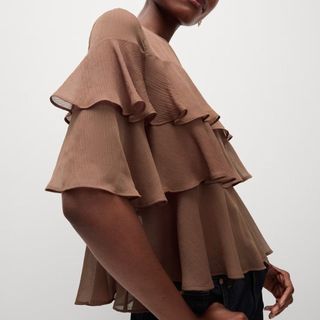 Flat lay image of woman wearing brown frill shirt 