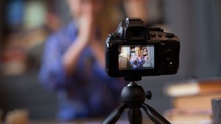 A vlogging camera mounted on mini tripod