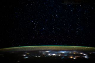 A vivid, green airglow blankets Earth's upper atmosphere under the starry night sky in this view from the International Space Station. An astronaut aboard the station captured this image on Dec. 29, 2019, when the station was orbiting about 260 miles (420 kilometers) above northern Iran, as it was about to pass over the Caspian Sea.