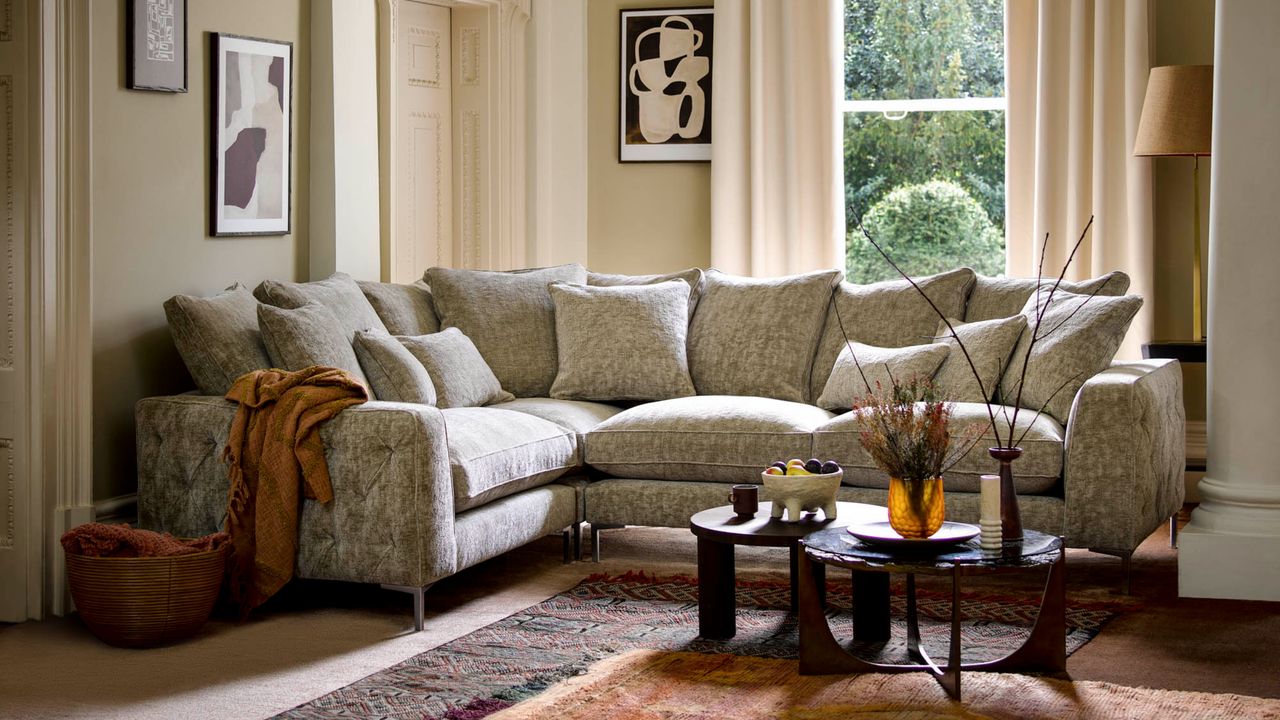 Grey sofa in living room, sofa cushions, coffee table, throw