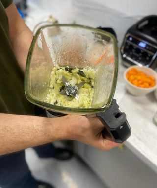 Alex David holding the Ninja Foodi Blender & Soup Maker Jug