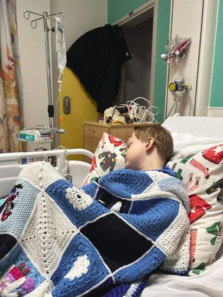 boy in a hospital bed in a blanket