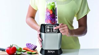 The Ninja Auto-UQ blender being used to make a smoothie