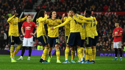Pierre-Emerick Aubameyang is congratulated by his Arsenal team-mates after equalising at Old Trafford