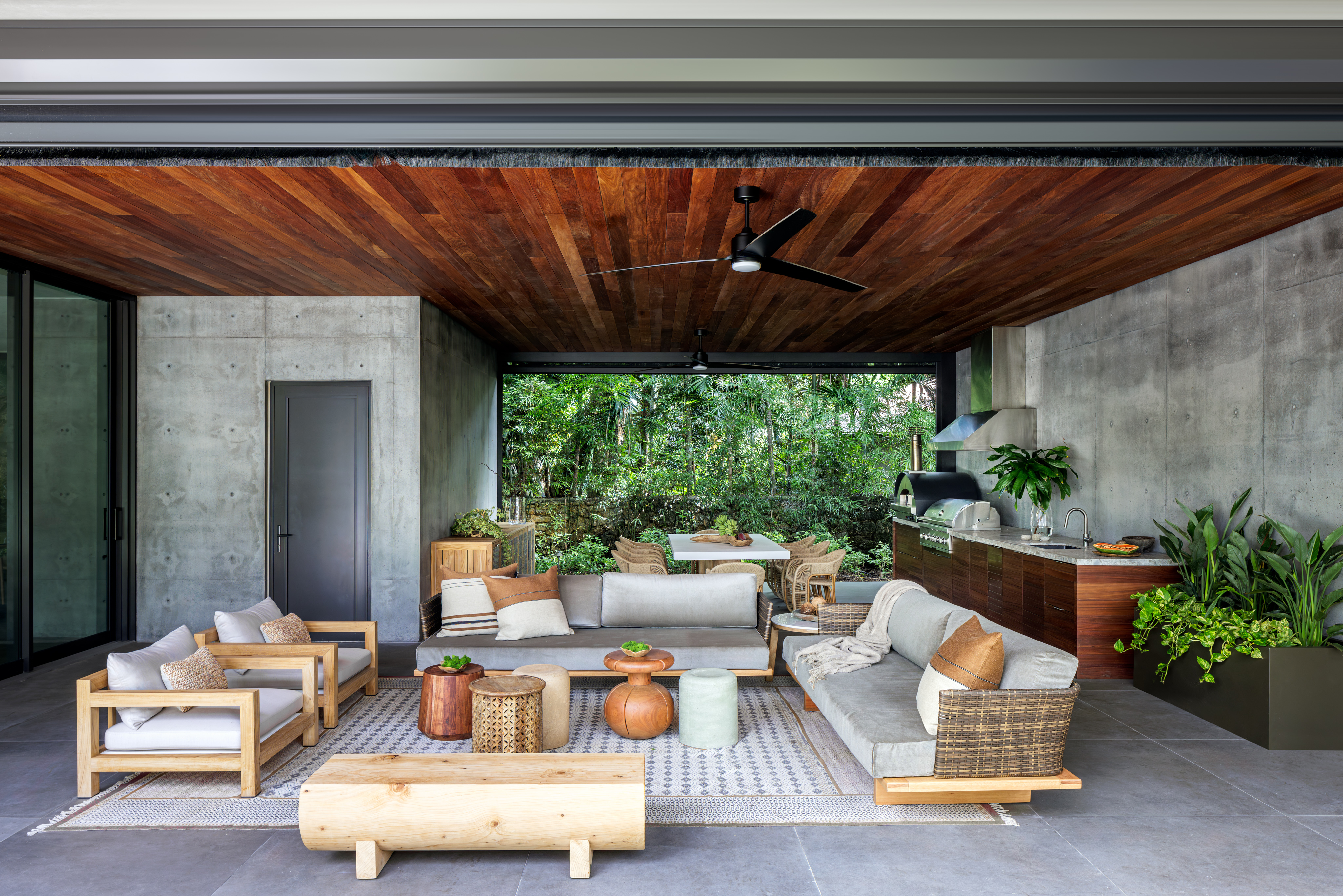 An outdoor space with seating, a dining room and a kitchen