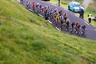 LUZ ARDIDEN FRANCE JULY 15 Dylan Van Baarle of The Netherlands and Team INEOS Grenadiers Tadej Pogaar of Slovenia and UAETeam Emirates Yellow Leader Jersey Jonas Vingegaard of Denmark and Team JumboVisma White Best Young Rider Jersey Wout Poels of The Netherlands and Team Bahrain Victorious Polka Dot Mountain Jersey The Peloton at Col du Tourmalet 2115m during the 108th Tour de France 2021 Stage 18 a 1297km stage from Pau to Luz Ardiden 1715m Fans Public LeTour TDF2021 on July 15 2021 in Luz Ardiden France Photo by Tim de WaeleGetty Images
