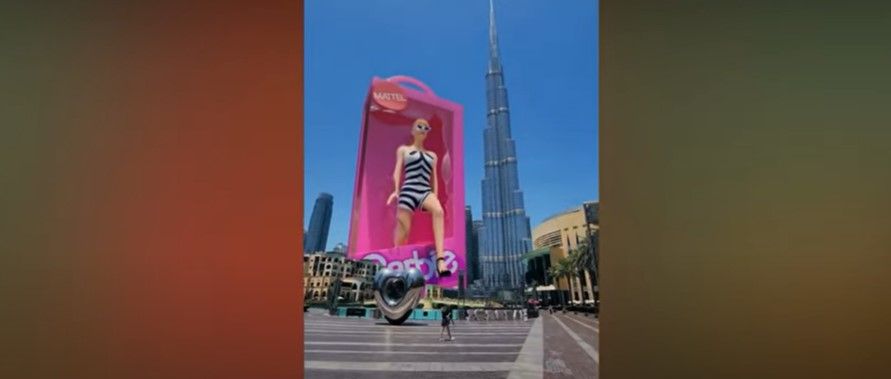 A massive Barbie 3D doll steps out of a box into a square in Dubai. 