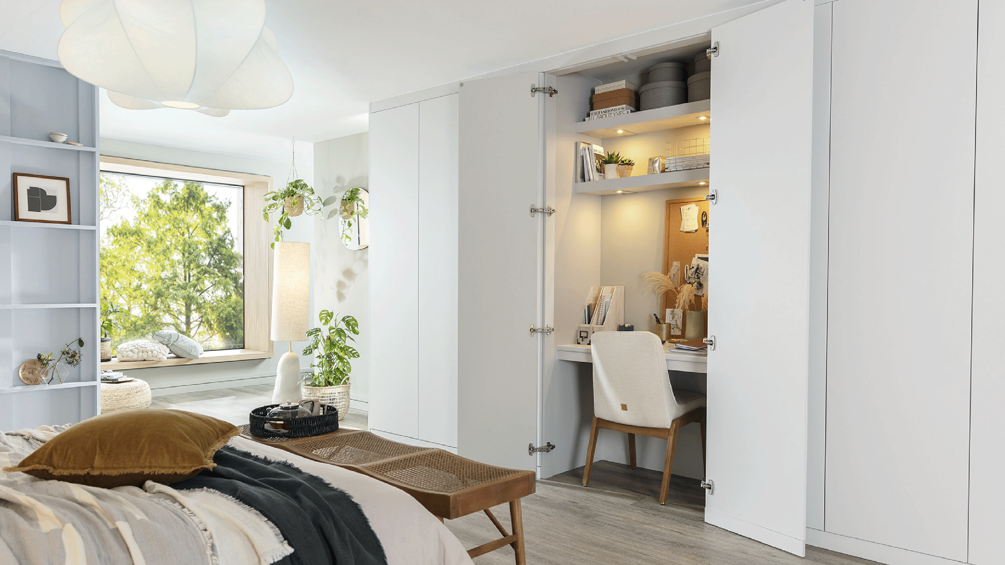 White bedroom with bed and desk in a cupboard